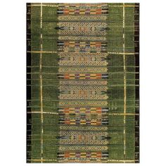 an area rug with different colors and patterns on the side, including green grass and brown stripes