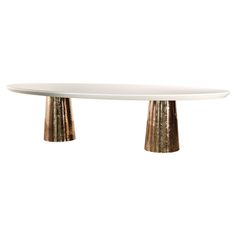 a white table with two gold legs on it