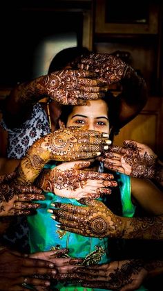 a woman with her hands covered in henna