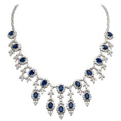 Necklace, finely crafted in 18k white gold with diamonds weighing a total of 16.52 carats and sapphires weighing a total of 16.58 carats. Circa 1990's. Formal Sapphire Diamond Necklace In Fine Jewelry Style, Formal Sapphire Necklace With Single Cut Diamonds, Sapphire Diamond Necklace For Formal Occasions, Formal Sapphire Diamond Necklace, Formal Sapphire Diamond Necklace With Brilliant Cut, Vintage Diamond Necklace, Gold Drop Necklace, Diamond Drop Necklace, Beaded Snowflakes