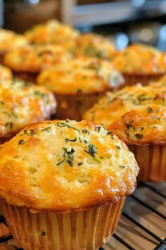 several muffins are cooling on a rack