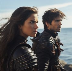 two people standing next to each other in front of the ocean, one wearing armor