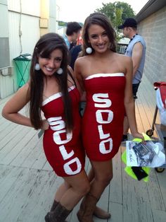 two women in red dresses standing next to each other