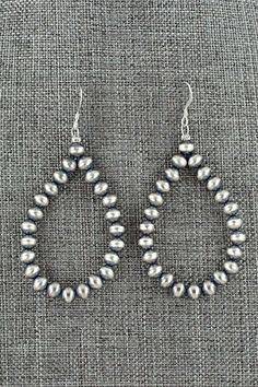 These sterling silver bead earrings were made by Navajo silversmith Louise Joe.Length: 2 5/8"Width: 1 1/4"Bead Size: 3/16"Free shipping on all orders! We ship with USPS and always include tracking. All orders ship within a day of payment.Returns are accepted up to 30 days after you receive your order. Just send us a message. Our shop offers cash back or store credit. The item must be returned in new condition. Traditional Silver Teardrop Beaded Earrings, Traditional Silver Nickel-free Beaded Earrings, Silver Drop Earrings With Silver Beads, Silver Teardrop Beaded Jewelry, Silver Bead Artisan Earrings, Artisan Silver Earrings With Silver Beads, Silver Dangle Jewelry With Polished Beads, Southwestern Sterling Silver Hand-strung Jewelry, Southwestern Style Silver Beaded Dangle Jewelry