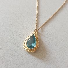 This 14k gold filled Blue Topaz necklace was designed in an antique style, with a bright Turquoise colored pendant in a teardrop shape. The gemstone birthstone necklace is handmade and delicate and the Blue Topaz is lab made. The gold Blue necklace is a great birthstone necklace for mom and the perfect gift for December birthdays. Dimensions: Pendant height is 0.7 inches and it is 0.47 inches wide. This pendant necklace is available in multiple lengths. Please choose on checkout. Materials: The Elegant Turquoise Teardrop Pendant Drop Necklace, Gold Pear-shaped Drop Necklace With Gemstone, Gold Drop Birthstone Necklace With Gemstone, Gold Drop Necklace With Birthstone, Gold Birthstone Drop Necklace, Gold Drop Necklace With Birthstone Teardrop Pendant, Gold Teardrop Pendant Necklace With Birthstone, Yellow Gold Teardrop Gemstone Drop Necklace, 14k Gold Teardrop Birthstone Necklace