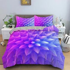 a bed covered in purple and blue sheets