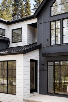 a white and black house with lots of windows