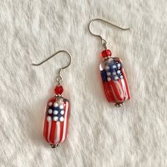 Show Your Patrotic Spirit This Fourth Of July With These Gorgeous Handcrafted Flag Earrings. Hand Blown Murano Glass Beads Paired With Complimenting Faceted Crystal Beads. Each Glass Bead Is Hand Blown With The Utmost Skill And Care, No 2 Beads Are Identical. These High Temperature Glass Beads Are Lightweight Yet Extremely Durable And Beautifully Vibrant In Color. Silver Hardware, Sterling Silver 925 Hook. Handmade Patriotic Drop Earrings, Adjustable Red Patriotic Earrings, Patriotic Multicolor Beaded Earrings, Patriotic Dangle Jewelry For Gifts, Handmade Patriotic Dangle Earrings, Patriotic Drop Earrings Jewelry Gift, Patriotic Handmade Beaded Earrings As Gift, Patriotic Handmade Beaded Earrings For Gift, Patriotic Nickel-free Earrings For Gift