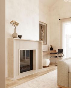 a living room with a fireplace and white furniture