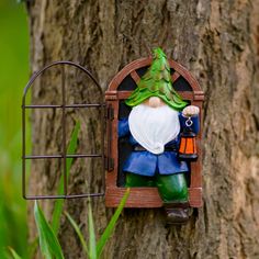 a gnome figurine sitting on top of a tree