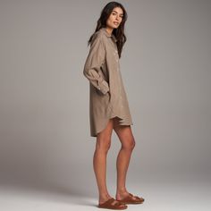 The Merritt has an easy, flowing drape and can be worn as loose top layer, a duster, or on its own as a dress. Made from luxe Tencel, a plant-based, eco-friendly fiber produced with with low amounts of water and a low carbon footprint. It is durable yet ultra-soft with an easy drape. The asymmetrical set-in and patch front pockets and double stitch reinforced placket and hem speak to classic utility with a modern, casual elegance. The double stitch reinforced inverted back pleat with triangle ta Chic Flowy Shirt Dress For Daywear, Fall Cotton Tunic Shirt Dress, Cotton Tunic Shirt Dress For Fall, Spring Relaxed Fit Shirt Dress For Daywear, Spring Daywear Dress With Shirttail Hem, Relaxed Fit Shirt Dress With Shirttail Hem For Fall, Fall Relaxed Fit Shirt Dress With Shirttail Hem, Casual Fall Shirt Dress With Shirttail Hem, Chic Fall Shirt Dress With Shirttail Hem