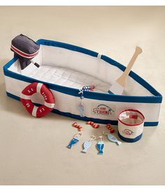 an inflatable boat with toys around it on a white flooring area,