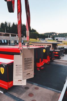 some red and black trucks are parked in a lot with tags hanging from the handles