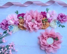 pink and white flowers are arranged on a blue background