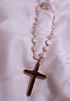 Add a unique twist to your jewelry collection with our Pearl Cross necklace. The 18" Baroque pearl necklace features a playful, irregular stainless steel and 18k gold-plated cross. It's the perfect mix of elegance and edginess! Pearl Drop Cross Necklace Gift, Pearl Drop Cross Pendant Necklace For Gift, Cross Pendant Necklace With Pearl Drop Gift, Pearl Drop Cross Pendant Necklace As Gift, Pearl Charm Cross Necklace For Gift, Pearl Cross Necklace With Pearl Drop As Gift, Gold Cross Necklace With Pearl Charm, Cross Necklace With Pearl Charm For Gifts, Pearl Drop Necklace With Cross Pendant As Gift