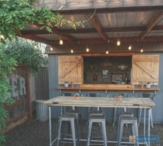 an outdoor bar with several stools and tables