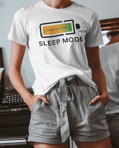 Introducing our Funny Sleep Mode T-Shirt with a Battery Logo - the perfect addition to your casual wardrobe! This unisex graphic tee features a clever and humorous design that showcases a battery icon with the words "Sleep Mode." It's ideal for anyone who loves tech humor and enjoys a good laugh. Crafted from high-quality, soft cotton, this novelty t-shirt ensures maximum comfort and durability, making it perfect for everyday wear. The sleep mode graphic is printed using eco-friendly inks, ensur Battery Logo, Funny Sleep, Gifts For Tech Lovers, Battery Icon, Tech Humor, Sleep Funny, Fun Conversation Starters, Tech T Shirts, Un Logo