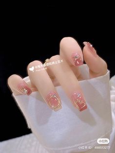 the manies are decorated with pink and gold designs on their fingertipss, as well as hearts