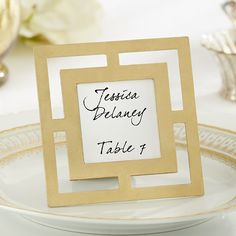 there is a place card on top of a plate with silverware in the background