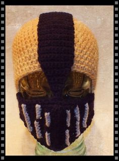 a knitted mask with two different colors on it