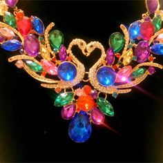 It's Difficult For Me To Tell You Just How Stunning This Necklace Is! The Necklace Is Made By Betsey Johnson And Is Signed On The Attached Hang Tag. The Necklace Is Done In A Gold Finish And Is Set With A Colorful Array Of Jewel Tone Rhinestones Forming A Design Of Two Kissing Swans At The Front. The Necklace Measures Up To 19" In Length And Is 3 3/4" In Width At The Center. In Excellent Condition And Amazingly Gorgeous! Rhinestone Statement Necklace, Betsey Johnson Jewelry, Wedding Board, Swans, Jewel Tones, Hang Tags, Gold Finish, Betsey Johnson, Womens Jewelry Necklace