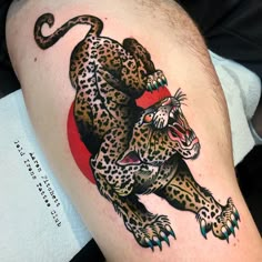 a tattoo on the arm of a man with a leopard