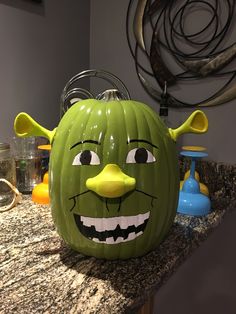 a green monster pumpkin sitting on top of a counter