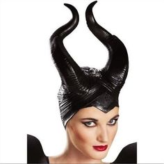 a woman with horns on her head wearing a black dress and caper wigs