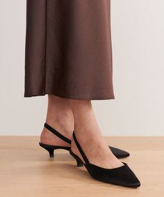 Satin Kitten Heel Black Fashioned in Italy, our Satin Kitten Heel is a modern take on an everyday classic. The satin touch brings a soft touch of sheen to any look. Pair this with jeans and a knit for an update on a classic outfit or style this with a blazer or dress for a buttoned-up moment. Made in Italy. Pointed toe satin upper with elastic slingback and kitten heel. Heel measures: 35mm. | Jenni Kayne Satin Kitten Heel Size 36 Sleek Fitted Kitten Heels For Night Out, Elegant Satin Heels For Night Out, Sleek Kitten Heels For Spring Formal Occasions, Elegant Fitted Kitten Heels With Sculpted Heel, Modern Fitted Kitten Heels For Evening, Elegant Fitted Kitten Heels For Gala, Elegant Ankle Strap Kitten Heels For Work, Elegant Kitten Heels With Ankle Strap, Elegant Ankle Strap Kitten Heels