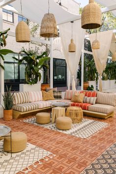 an outdoor living area with wicker furniture and plants