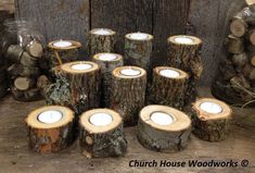 several logs with candles in them sitting next to each other