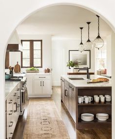 an archway in the middle of a kitchen