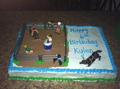 a birthday cake that is shaped like a boxing ring with people around it and on the ground