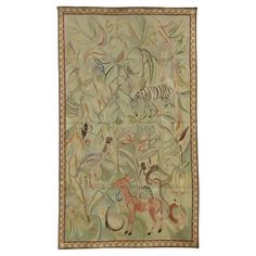 an embroidered wall hanging with animals and plants on it's sides, including zebras