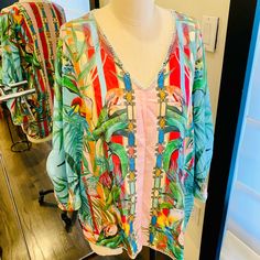 Such A Gorgeous Print Of Flowers And Birds On This Easy To Wear Blouse. The V Neck And Convertible Sleeves Makes It Super Stylish. Designed With A Vibrant Multicolor Tropical Print, It Gives You Effortless Versatility. That Lush, Tropical Details Make This Blouse Truly Something Special. Made Of Ultra-Soft Silk, It Will Quickly Become Your Favorite Piece To Layer This Season. From Parties To Walks Around The City, You Can Pair This With Your Favorite Skirt Or Jeans For A Laid-Back Boho Look. V-neck Top With Tropical Print For Brunch, Summer V-neck Blouse With Tropical Print, Tropical V-neck Blouse For Beach, Summer Multicolor Blouson Sleeve Tops, Beachwear V-neck Tops With Tropical Print, Multicolor Blouson Sleeve Summer Top, Floral Print V-neck Beachwear Top, Multicolor Blouson Sleeves Top For Summer, Long Sleeve Printed Beachwear Tops