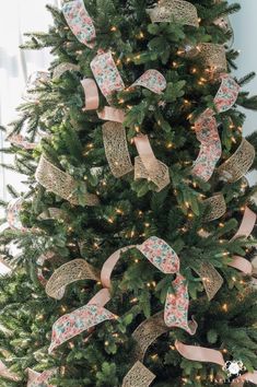 a decorated christmas tree with bows and lights