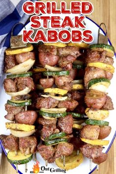 grilled steak kabobs on a white plate with text overlay that reads grilled steak kabobs