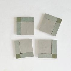 four pieces of cement sitting next to each other on a white surface with one piece missing