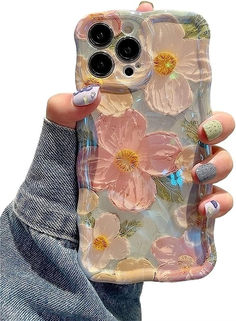 a woman holding up her phone case with flowers on it