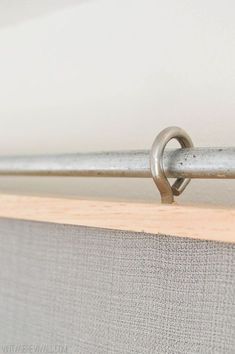 a close up of a curtain with a metal hook on the top and bottom part