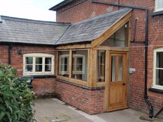 a brick building with a wooden door and windows