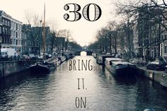 there are many boats on the water in this city canal that says, 30 bring it on