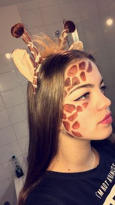 a girl with giraffe print on her face and hair in the shape of a head