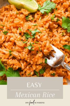 mexican rice in a white bowl with cilantro and lime wedges on the side