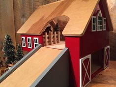 a wooden toy house with a ramp leading up to it