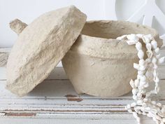 two clay pots sitting next to each other on a table