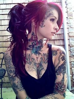 a woman with tattoos on her neck and chest