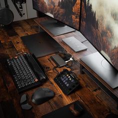 a desk with two computer monitors, keyboard and mouse next to each other on it