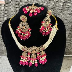 Beautiful brass based Polki Kundan and Moti Jwellery set . Comes with maang tikka , earrings and a choker necklace. The set is finished beautifully at the back with meenakari...the set comes in pastel shades of pink and green and is just splendid. Its intricate designs and stunning details add an elegant touch to your look. Upgrade your jewellery collection with this timeless set. Handmade Brass Jewelry For Party, Festive Celebration Jewelry With Latkans, Wedding Brass Chandbali Jewelry, Hand Set Jewelry Sets For Diwali, Traditional Brass Necklace For Party, Festive Gold Plated Tikka As A Gift, Hand Set Jewelry For Diwali Festival, Brass Jewelry Sets For Wedding And Festive Occasions, Festive Brass Jewelry Sets For Wedding