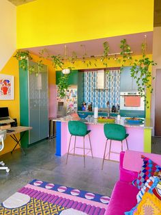 a brightly colored room with chairs, desks and plants on the wall in it